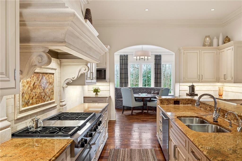 5148 Powers Ferry Road Northwest Sandy Springs, GA 30327 - Photo 11 of 63 a kitchen with stainless steel appliances granite countertop a stove and a sink