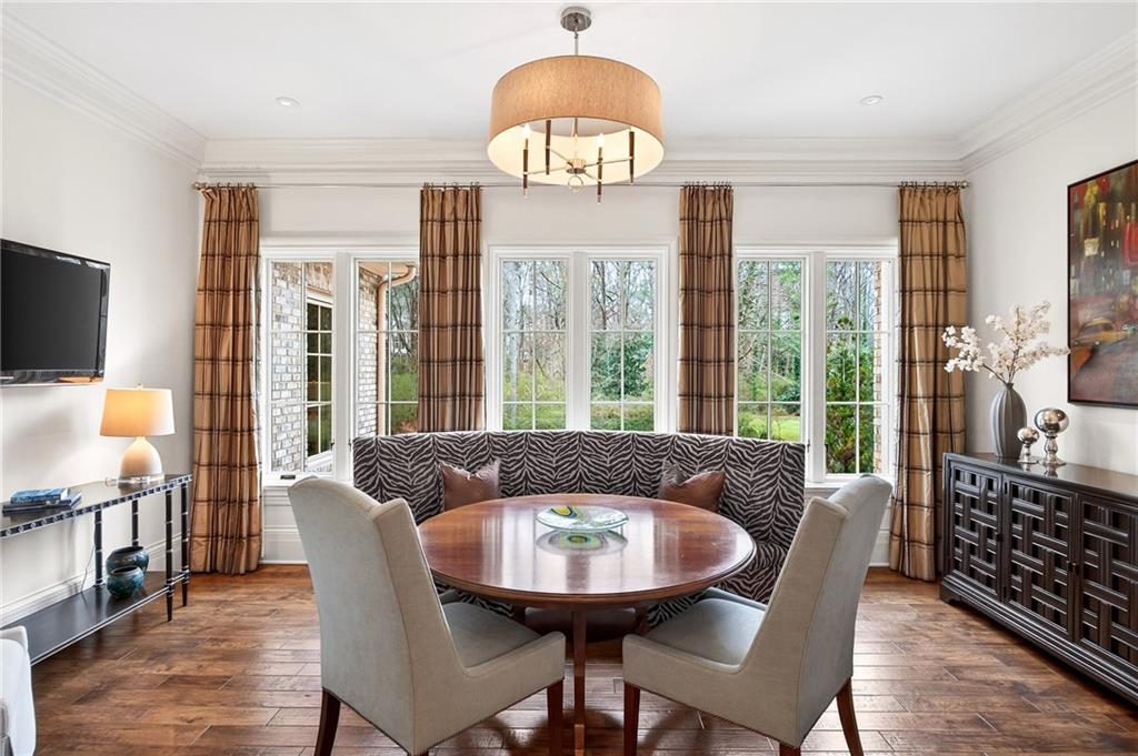 5148 Powers Ferry Road Northwest Sandy Springs, GA 30327 - Photo 12 of 63 a view of a dining room with furniture window and wooden floor