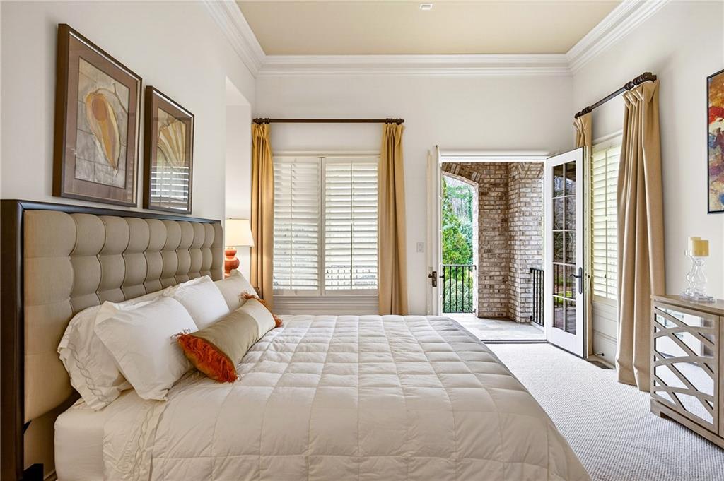 5148 Powers Ferry Road Northwest Sandy Springs, GA 30327 - Photo 19 of 63 a bedroom with a large bed and a large window