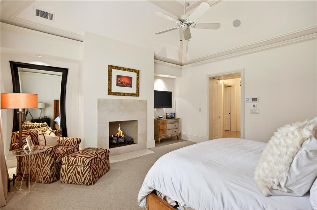5148 Powers Ferry Road Northwest Sandy Springs, GA 30327 - Photo 25 of 63 a spacious bedroom with a bed and a fireplace