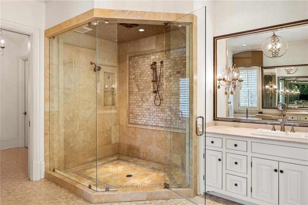 5148 Powers Ferry Road Northwest Sandy Springs, GA 30327 - Photo 29 of 63 a bathroom with a shower a mirror and a sink