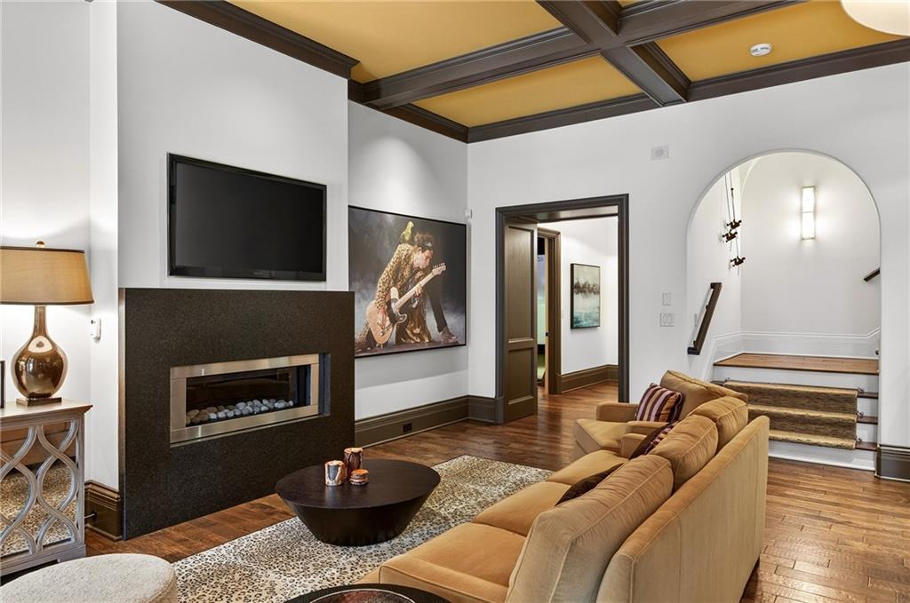 5148 Powers Ferry Road Northwest Sandy Springs, GA 30327 - Photo 36 of 63 a living room with furniture a flat screen tv and a fireplace