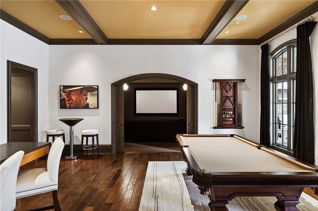 5148 Powers Ferry Road Northwest Sandy Springs, GA 30327 - Photo 39 of 63 a living room with furniture a flat screen tv and wooden floor