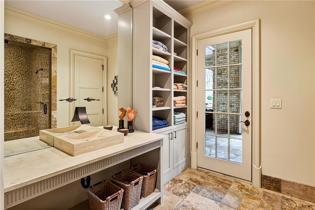 5148 Powers Ferry Road Northwest Sandy Springs, GA 30327 - Photo 47 of 63 a bathroom with a double vanity sink a mirror and a shower