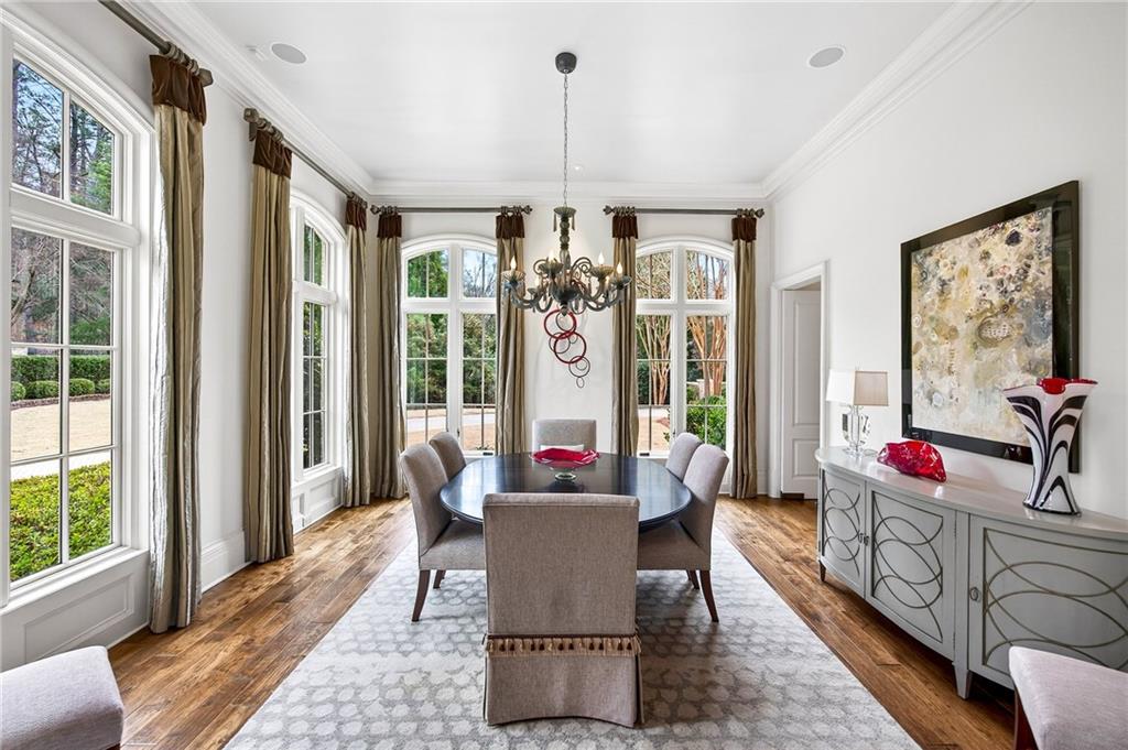5148 Powers Ferry Road Northwest Sandy Springs, GA 30327 - Photo 5 of 63 a dining room with wooden floor and large windows