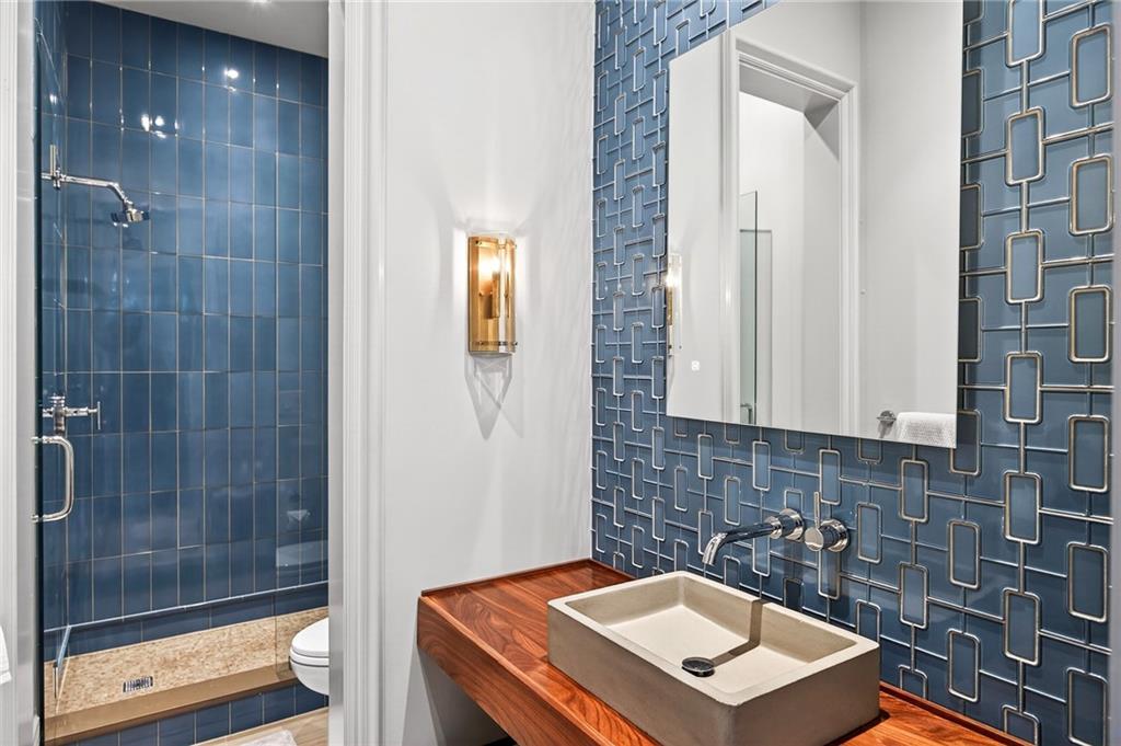 5148 Powers Ferry Road Northwest Sandy Springs, GA 30327 - Photo 53 of 63 a bathroom with a sink a toilet and shower