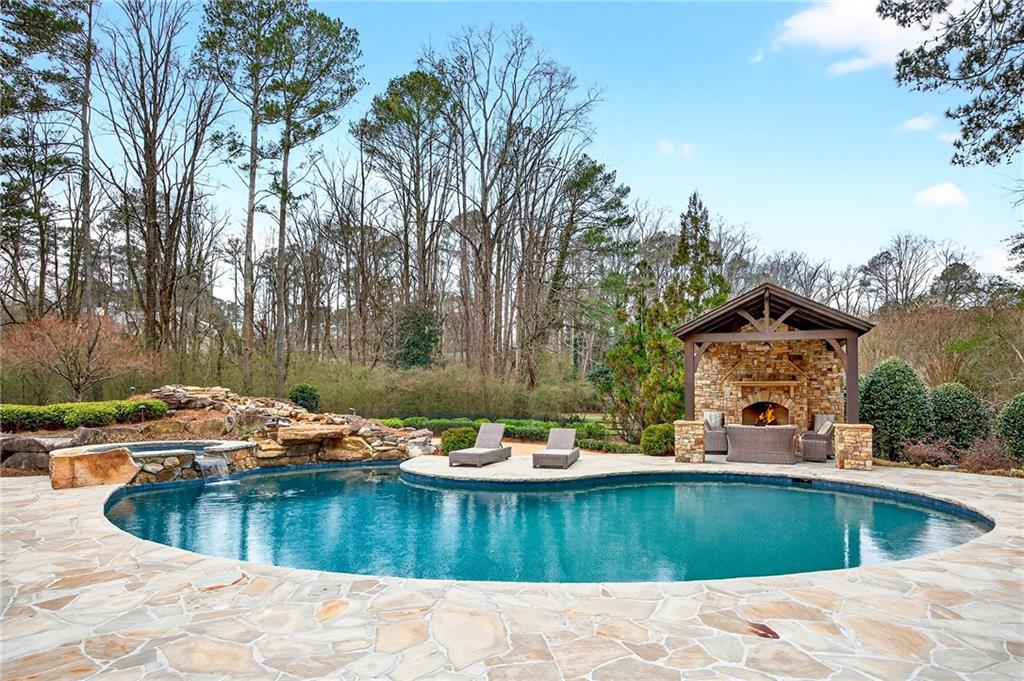 5148 Powers Ferry Road Northwest Sandy Springs, GA 30327 - Photo 55 of 63 a view of a swimming pool with a patio
