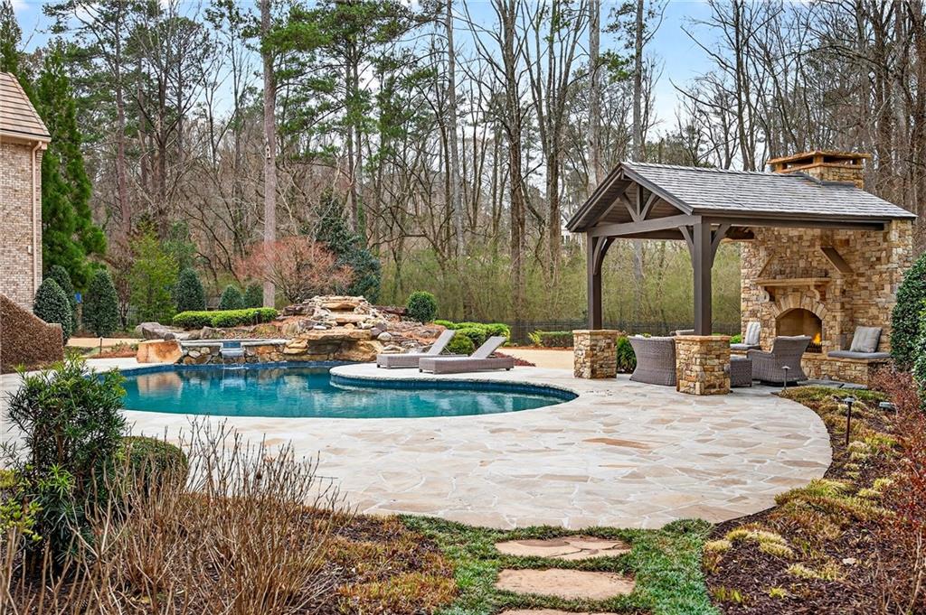 5148 Powers Ferry Road Northwest Sandy Springs, GA 30327 - Photo 56 of 63 a view of a house with backyard and sitting area