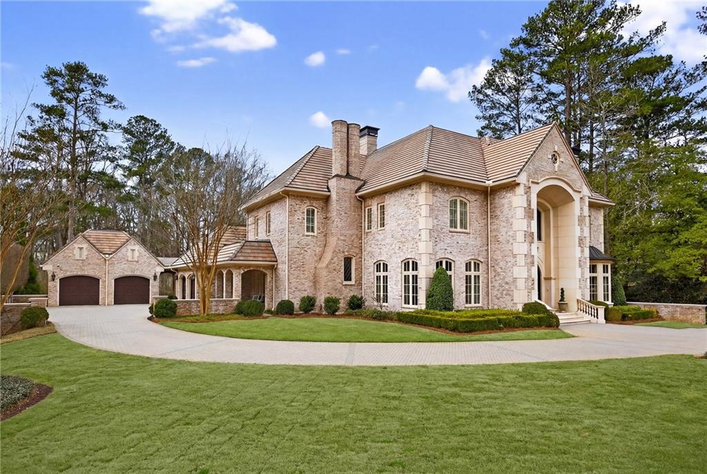 5148 Powers Ferry Road Northwest Sandy Springs, GA 30327 - Photo 57 of 63 a front view of a house with a garden