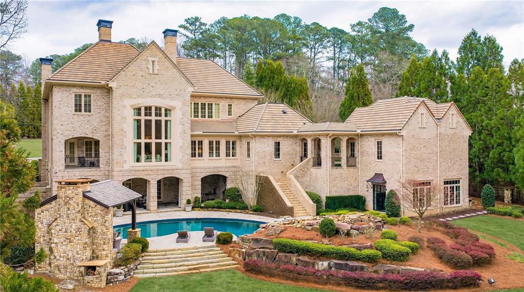 5148 Powers Ferry Road Northwest Sandy Springs, GA 30327 - Photo 60 of 63 a front view of a house with a yard