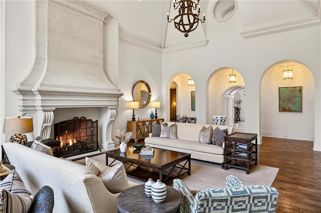 5148 Powers Ferry Road Northwest Sandy Springs, GA 30327 - Photo 6 of 63 a living room with furniture a fireplace and a chandelier