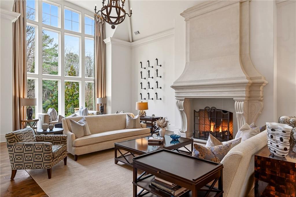 5148 Powers Ferry Road Northwest Sandy Springs, GA 30327 - Photo 7 of 63 a living room with furniture a lamp and a fireplace