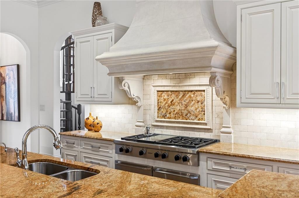 5148 Powers Ferry Road Northwest Sandy Springs, GA 30327 - Photo 10 of 63 a kitchen with stainless steel appliances granite countertop a stove and a sink