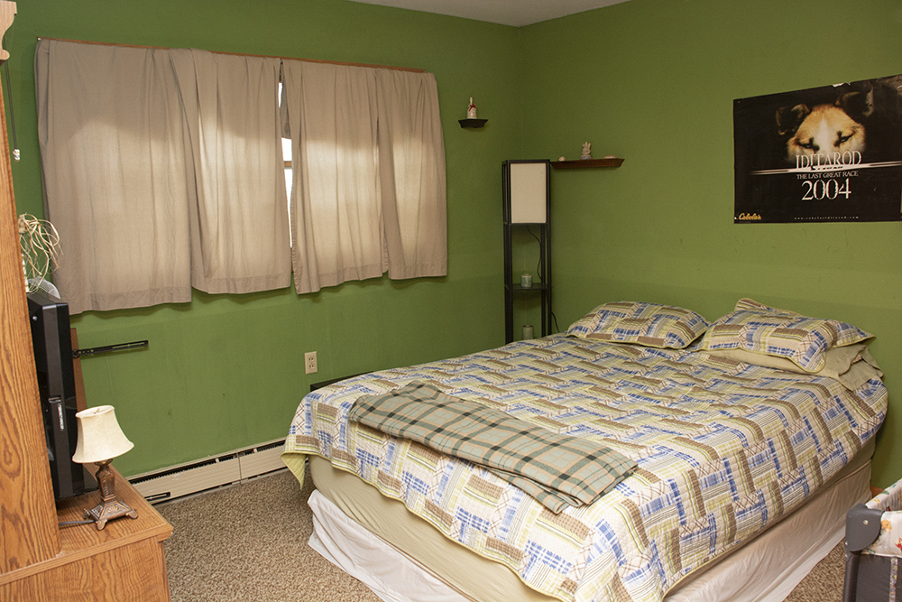 7849 Benson Road Lanark, IL 61046 - Photo 14 of 45 a bed sitting in a bedroom next to a window