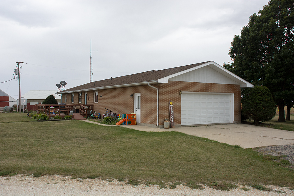 7849 Benson Road Lanark, IL 61046 - Photo 6 of 45 a front view of a house with a garden and yard