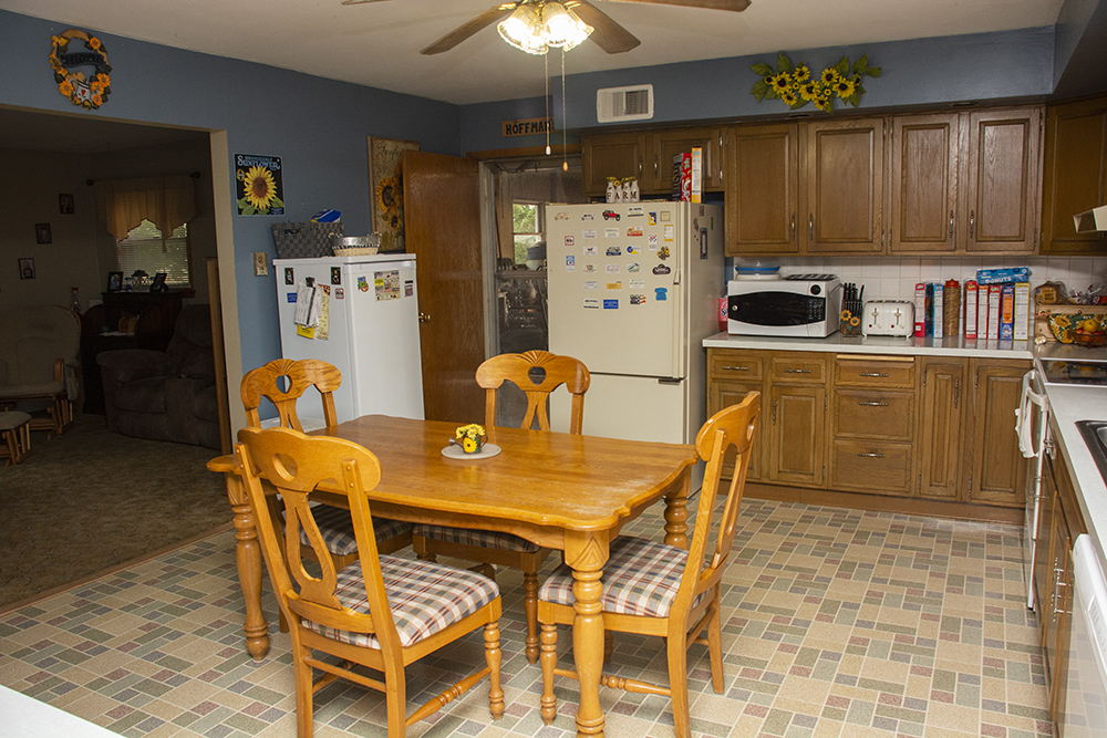 7849 Benson Road Lanark, IL 61046 - Photo 9 of 45 a dining table chairs and a refrigerator in a kitchen