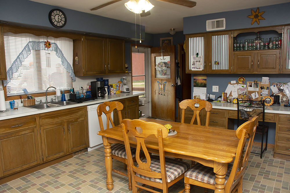 7849 Benson Road Lanark, IL 61046 - Photo 10 of 45 a dining hall with stainless steel appliances granite countertop a stove a sink dishwasher and cabinets with wooden floor