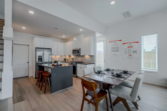 a kitchen with a table and chairs in it