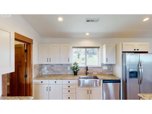 a kitchen with kitchen island a stove and a cabinets