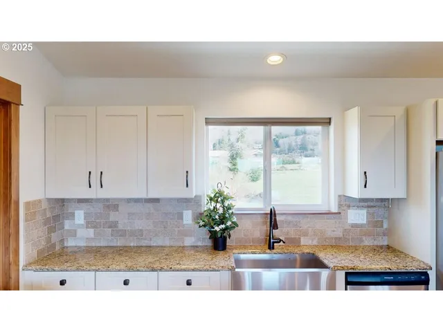 a open kitchen with sink and cabinets