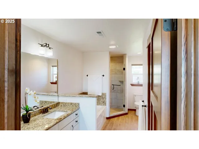 a bathroom with a sink double vanity and mirror
