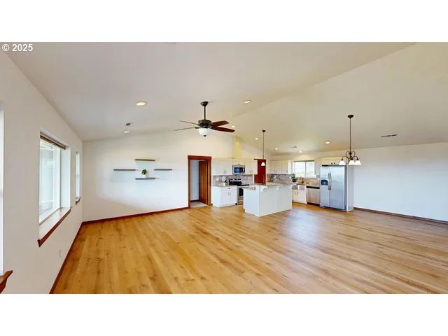 a living room with kitchen island furniture and a wooden floor