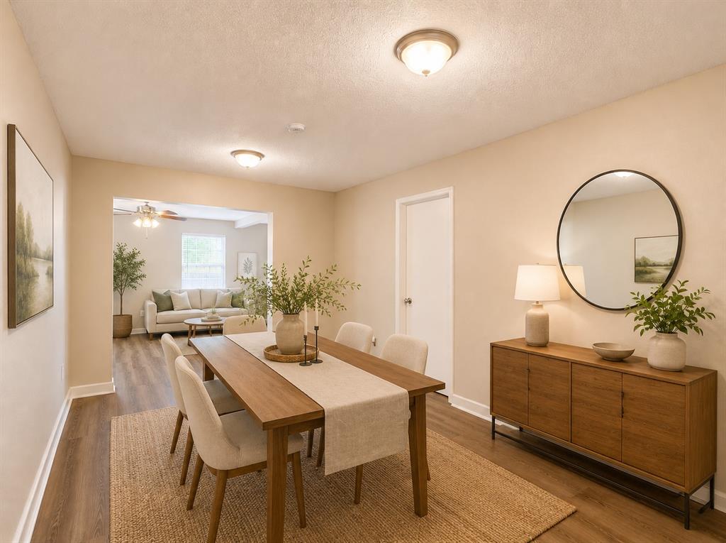 1231 Rutherford Drive Mesquite, TX 75149 - Photo 22 of 29 a dining room with furniture a mirror and wooden floor