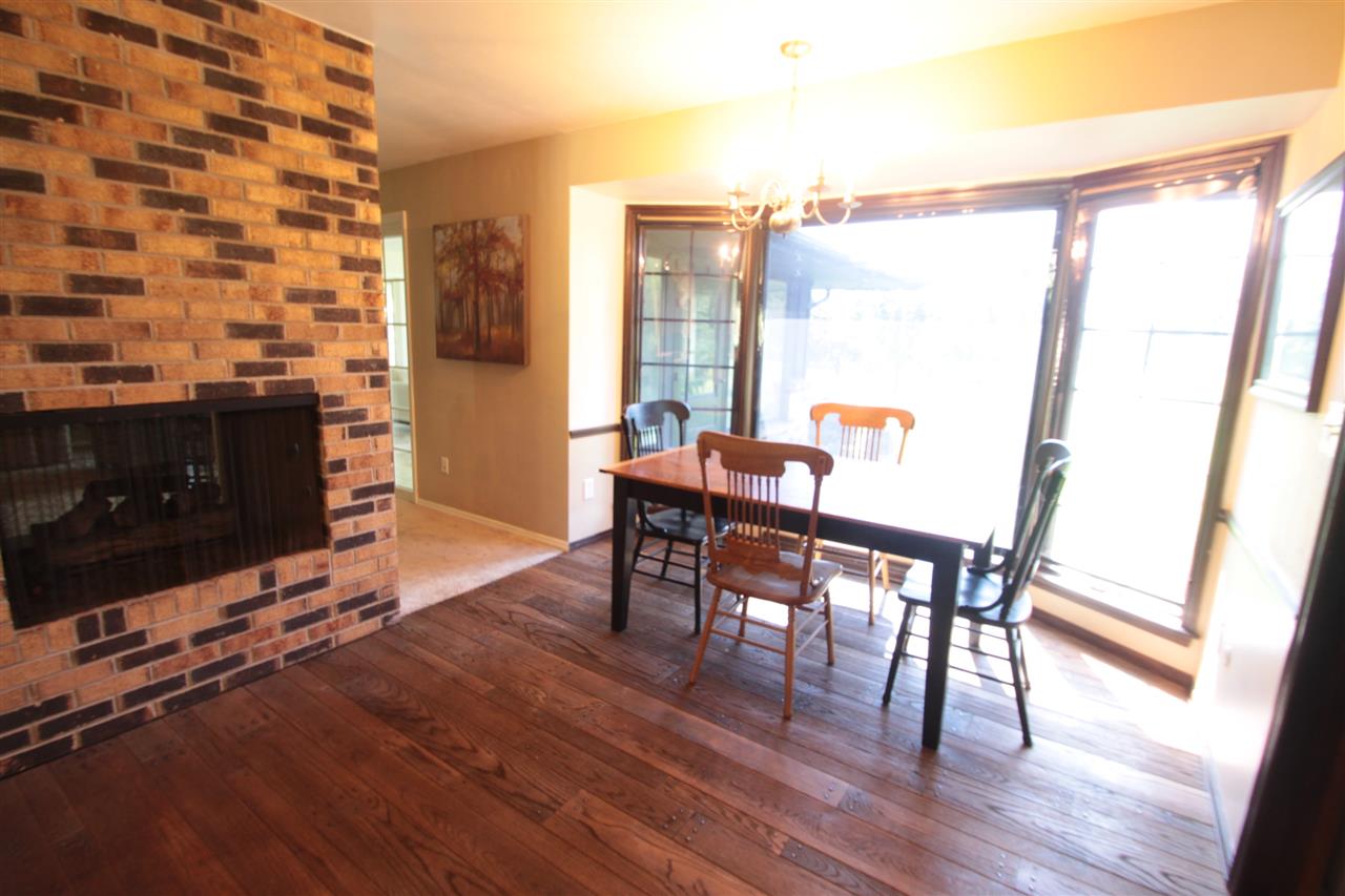 1138 Roxbury Road Rockford, IL 61107 - Photo 11 of 25 a dining room with furniture and wooden floor