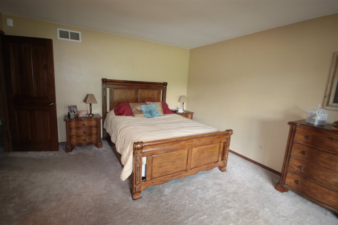 1138 Roxbury Road Rockford, IL 61107 - Photo 12 of 25 a room with a bed and a dresser