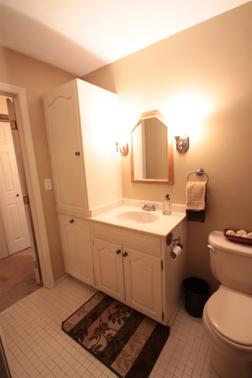 1138 Roxbury Road Rockford, IL 61107 - Photo 13 of 25 a bathroom with a sink toilet and mirror