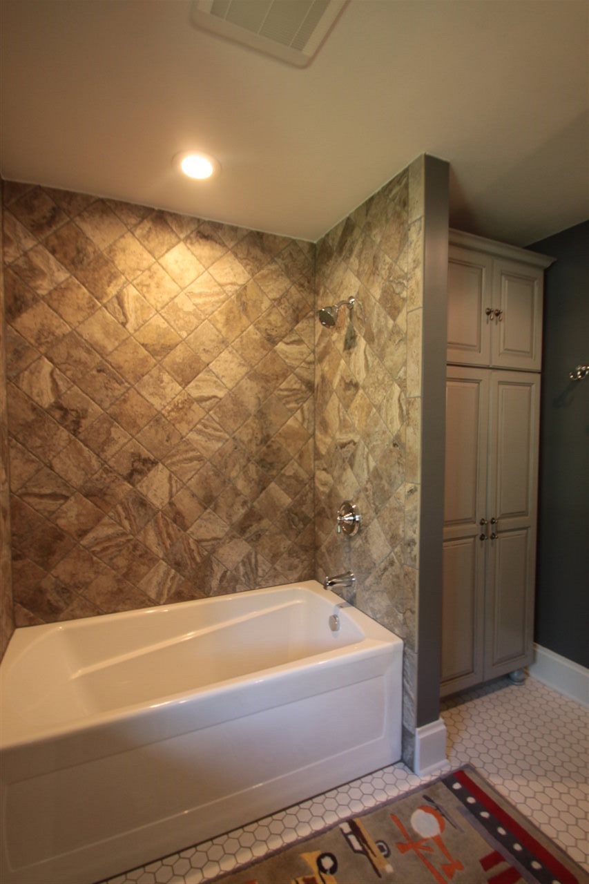 1138 Roxbury Road Rockford, IL 61107 - Photo 16 of 25 a bathroom with a bathtub and a shower