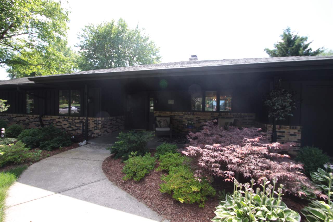 1138 Roxbury Road Rockford, IL 61107 - Photo 2 of 25 a view of a back yard of the house and flowers