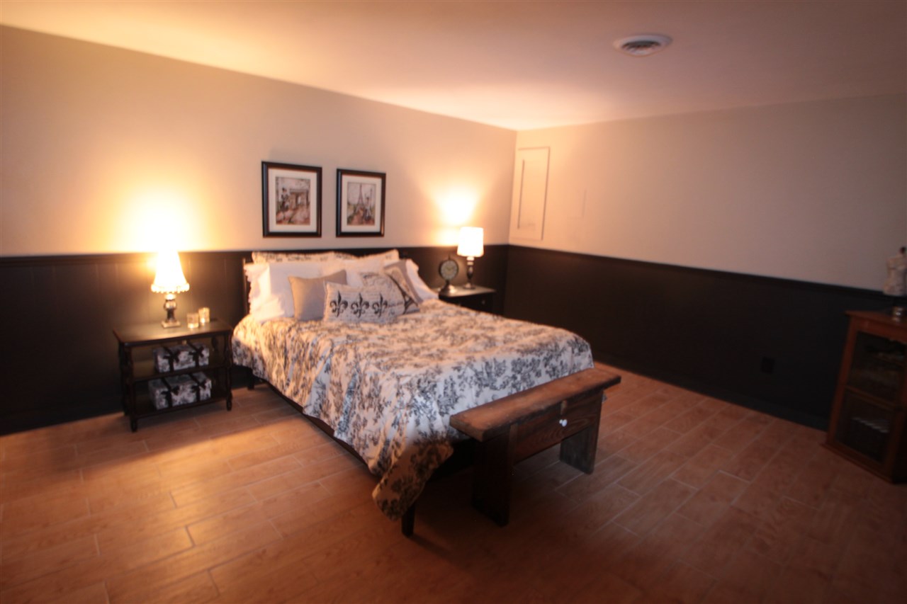 1138 Roxbury Road Rockford, IL 61107 - Photo 23 of 25 a bedroom with a bed and lamp with window