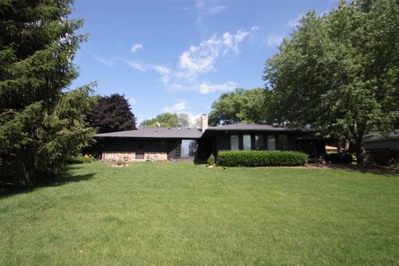 1138 Roxbury Road Rockford, IL 61107 - Photo 25 of 25 a front view of a house with a yard and garage