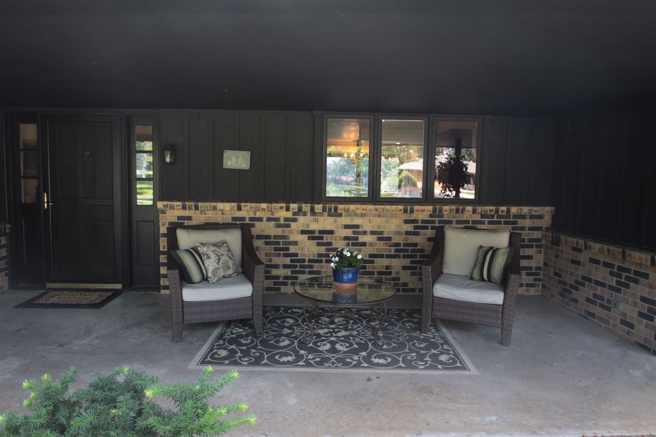 1138 Roxbury Road Rockford, IL 61107 - Photo 3 of 25 a living room with a couch and a potted plant