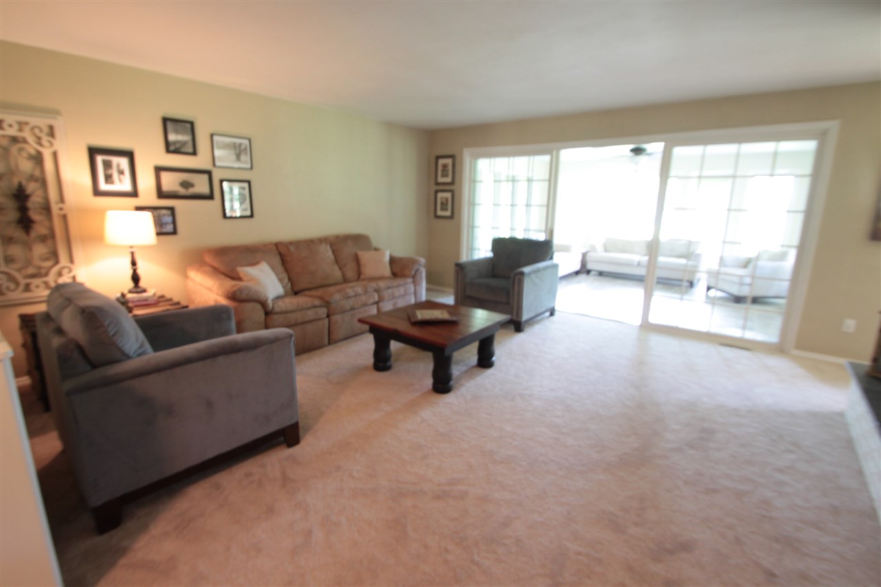 1138 Roxbury Road Rockford, IL 61107 - Photo 4 of 25 a living room with couches and a large window with outer view