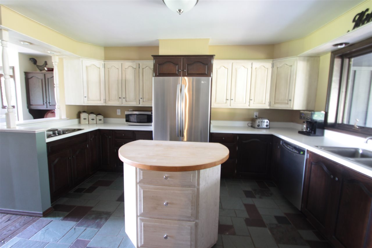 1138 Roxbury Road Rockford, IL 61107 - Photo 7 of 25 a kitchen with a sink stove and refrigerator