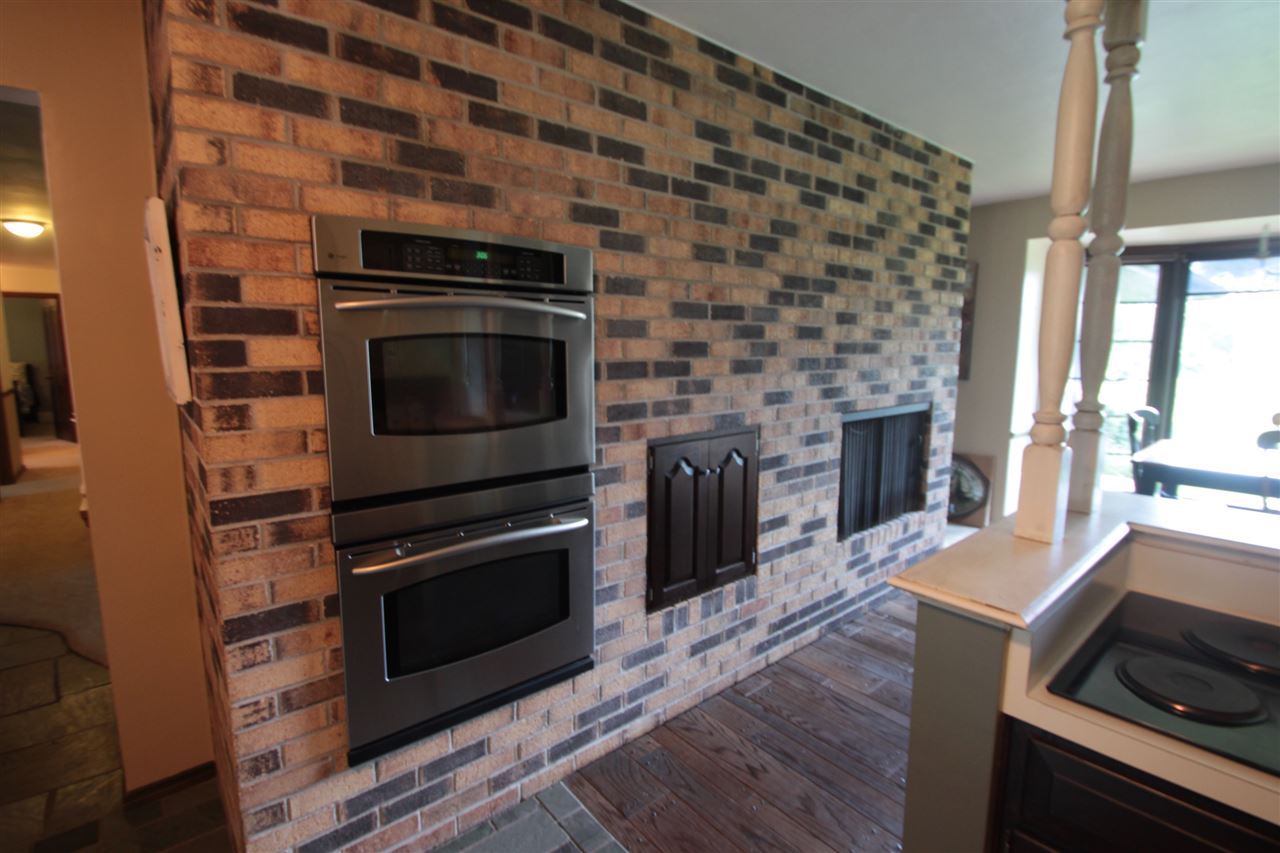 1138 Roxbury Road Rockford, IL 61107 - Photo 8 of 25 a kitchen with granite countertop a stove and a microwave