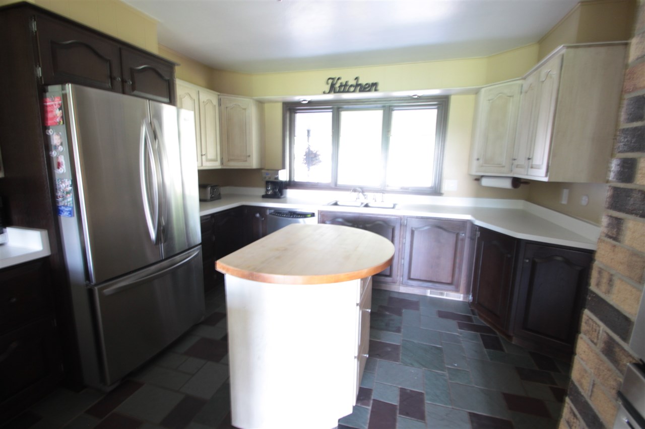 1138 Roxbury Road Rockford, IL 61107 - Photo 9 of 25 a kitchen with granite countertop stainless steel appliances a refrigerator sink and window