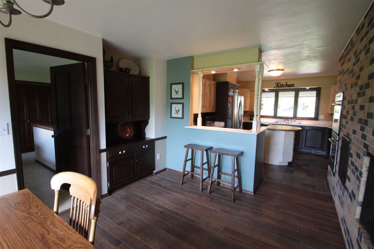 1138 Roxbury Road Rockford, IL 61107 - Photo 10 of 25 a kitchen with a table chairs refrigerator and microwave