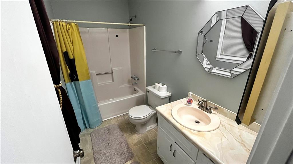 975 Ridgedale Drive Lawrenceville, GA 30043 - Photo 11 of 31 a bathroom with a sink a toilet and a mirror