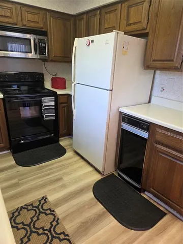 a white refrigerator freezer and a dishwasher sitting in a kitchen