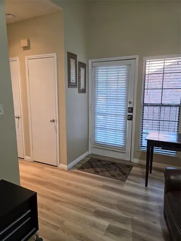 a view of room with window and wooden floor