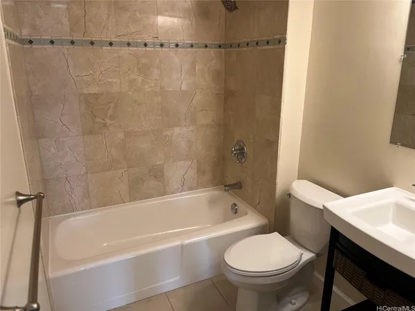 a white bath tub sitting next to a white toilet and a sink