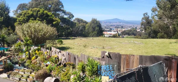 a view of a swimming pool with a patio and a yard