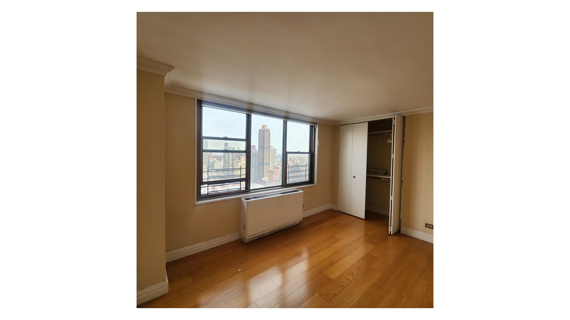 301 East 79th Street, Unit 32F Manhattan, NY 10075 - Photo 9 of 21 a view of an empty room with a window