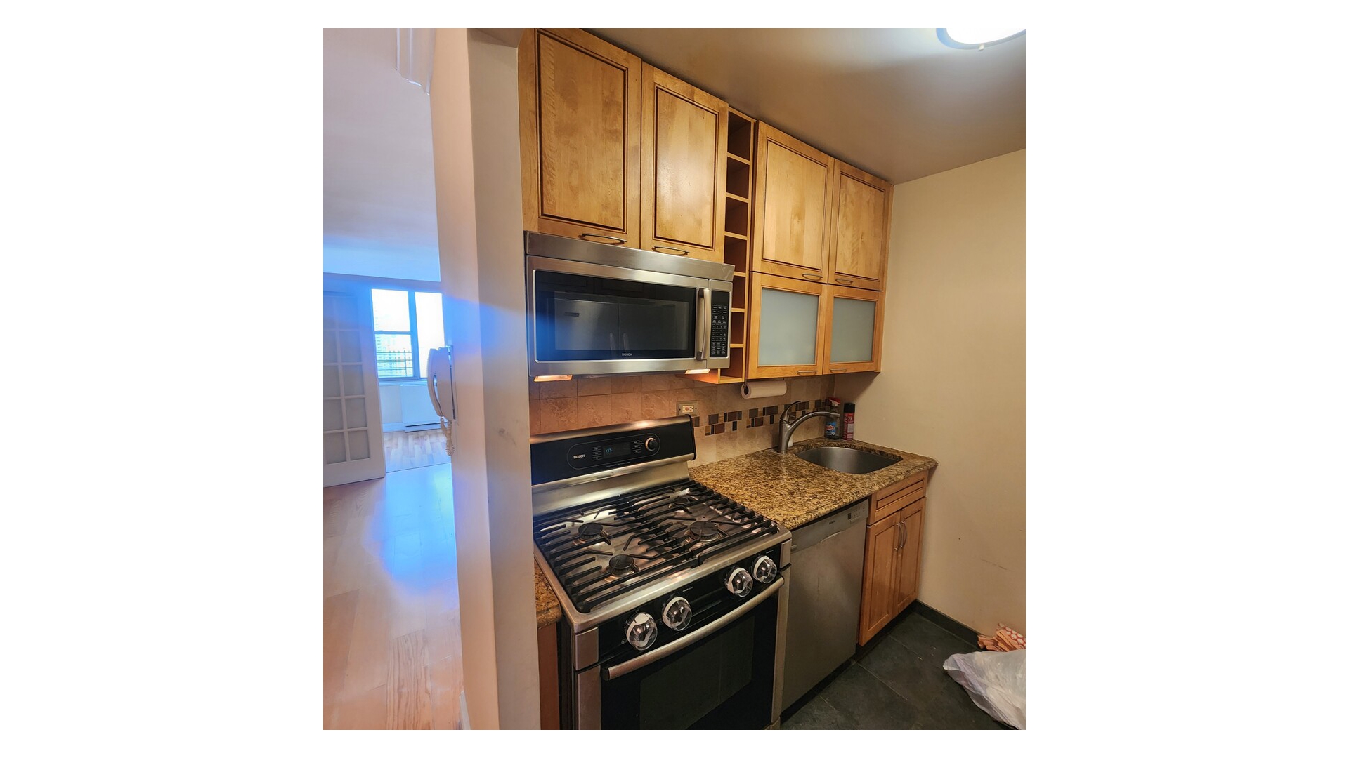 301 East 79th Street, Unit 32F Manhattan, NY 10075 - Photo 15 of 21 a kitchen with stainless steel appliances granite countertop a stove and a refrigerator