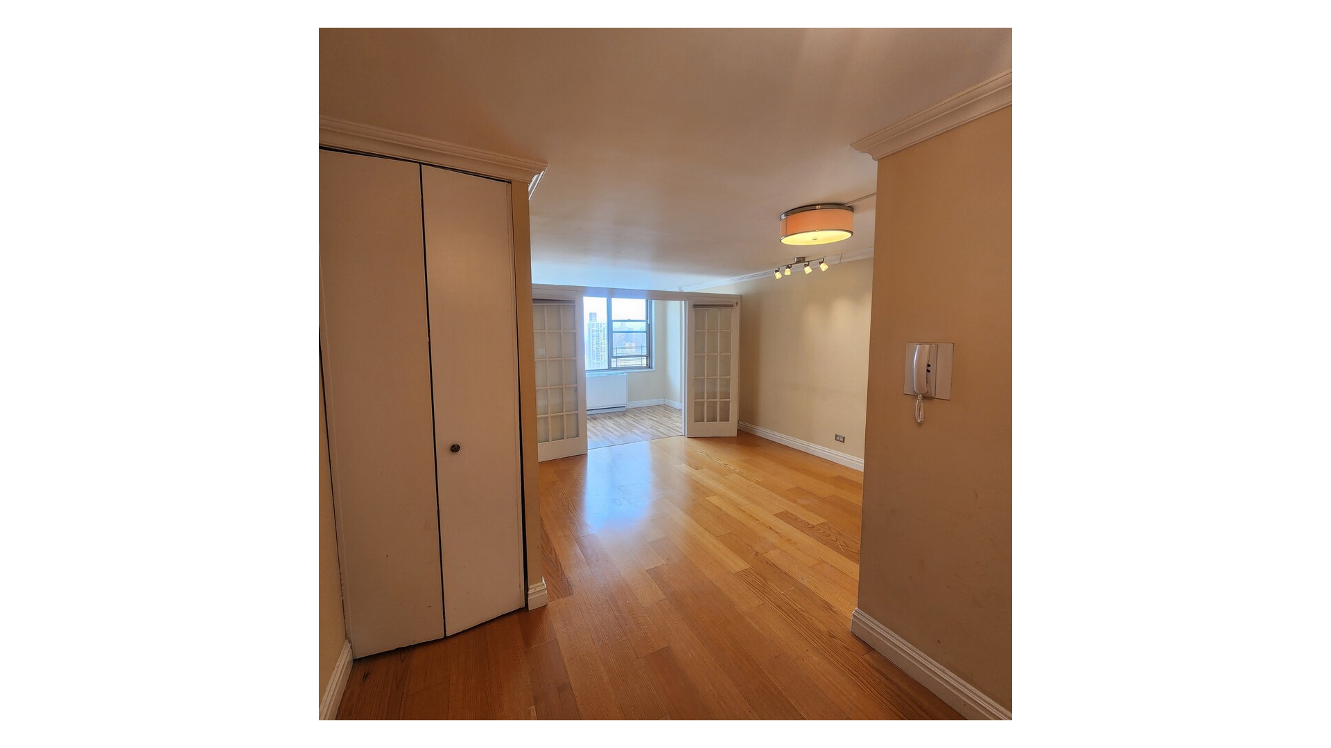 301 East 79th Street, Unit 32F Manhattan, NY 10075 - Photo 16 of 21 a view of a room with wooden floor and a bathroom