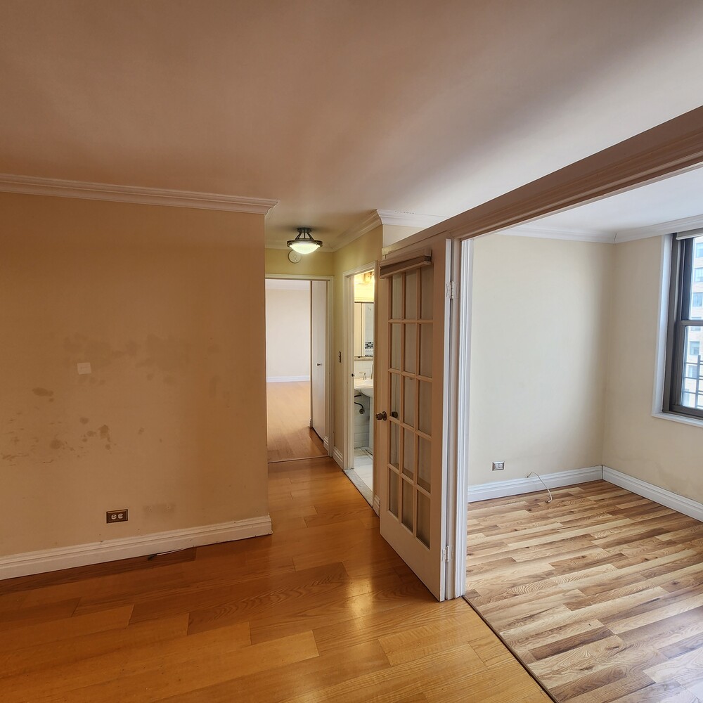 301 East 79th Street, Unit 32F Manhattan, NY 10075 - Photo 19 of 21 a view of a room with wooden floor and a window
