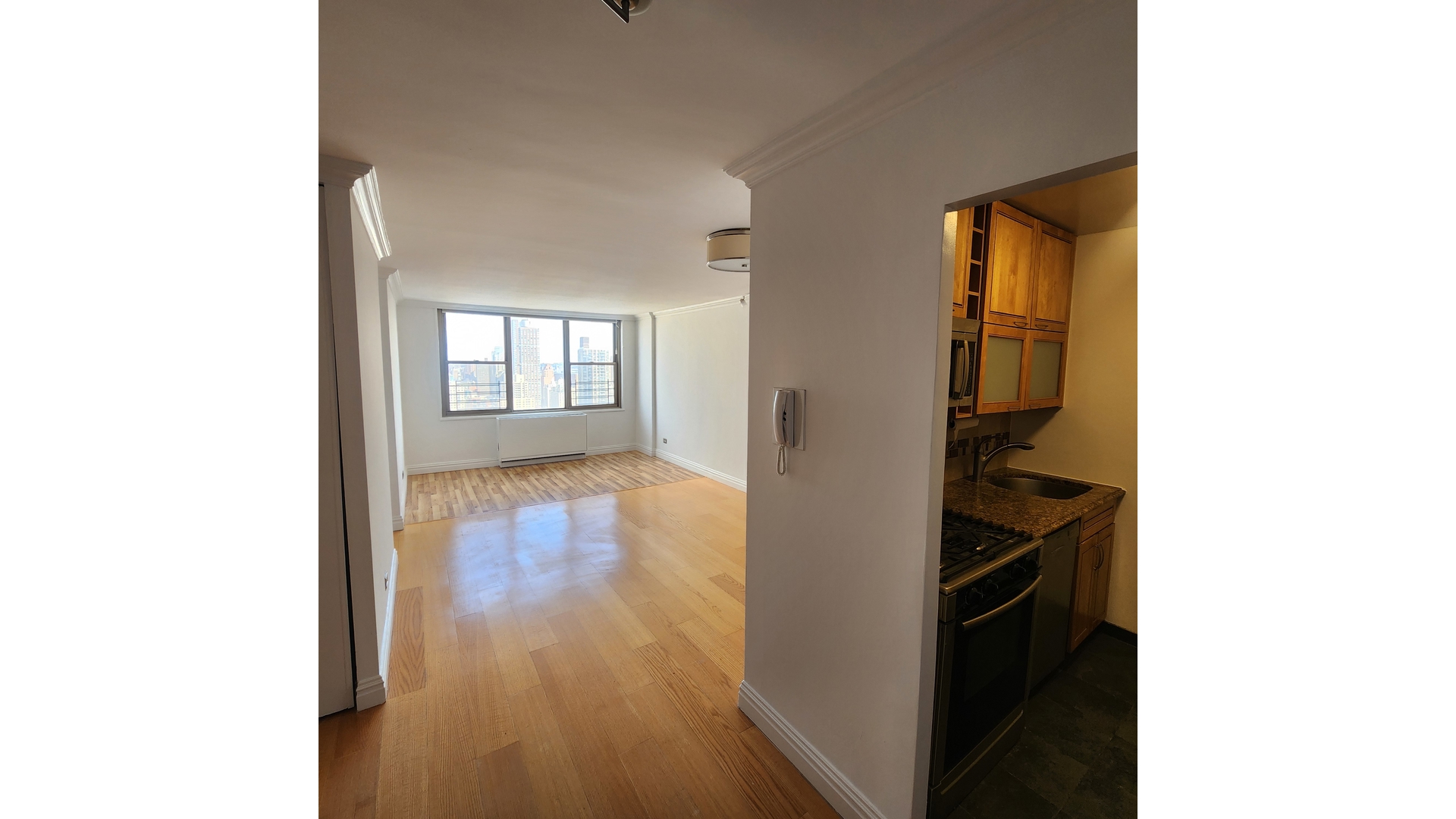 301 East 79th Street, Unit 32F Manhattan, NY 10075 - Photo 3 of 21 a view of a room that has a bed and a window in it